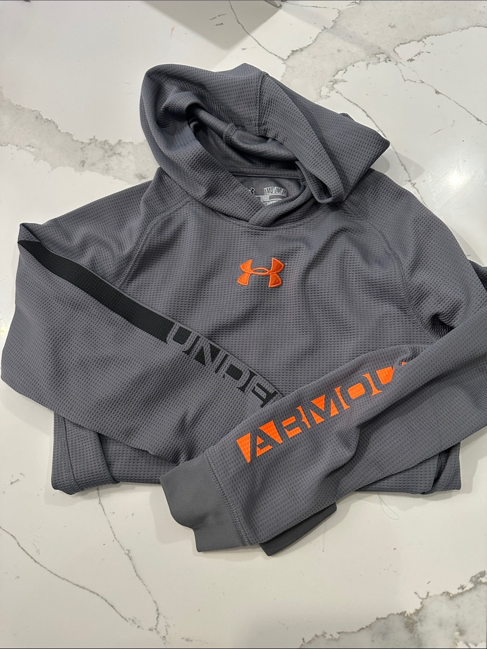 Under Armour Gray Hoodie with Orange Logo and Sleeve Accents in dryfit material